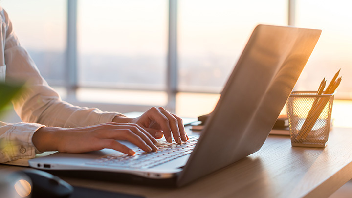 Hands working on a laptop