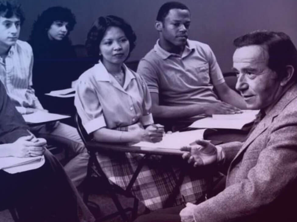 A black and white photo of students and a teacher in a classroom