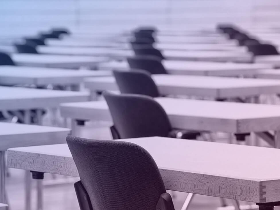 Rows of desks and chairs in a room