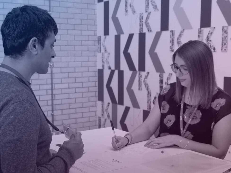 a man signing in at a Kaplan office